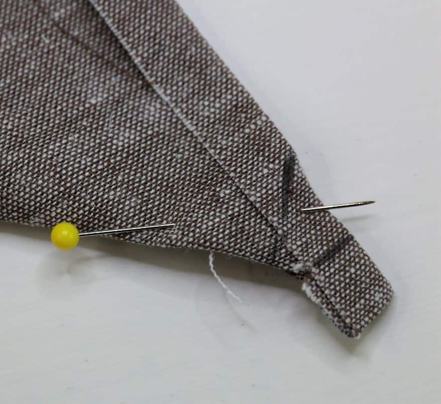 Ecke mit Stecknadel sichern